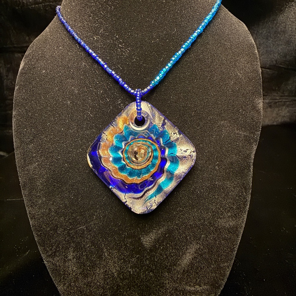 Vibrant Blue and Teal with swirls of gold and sliver.